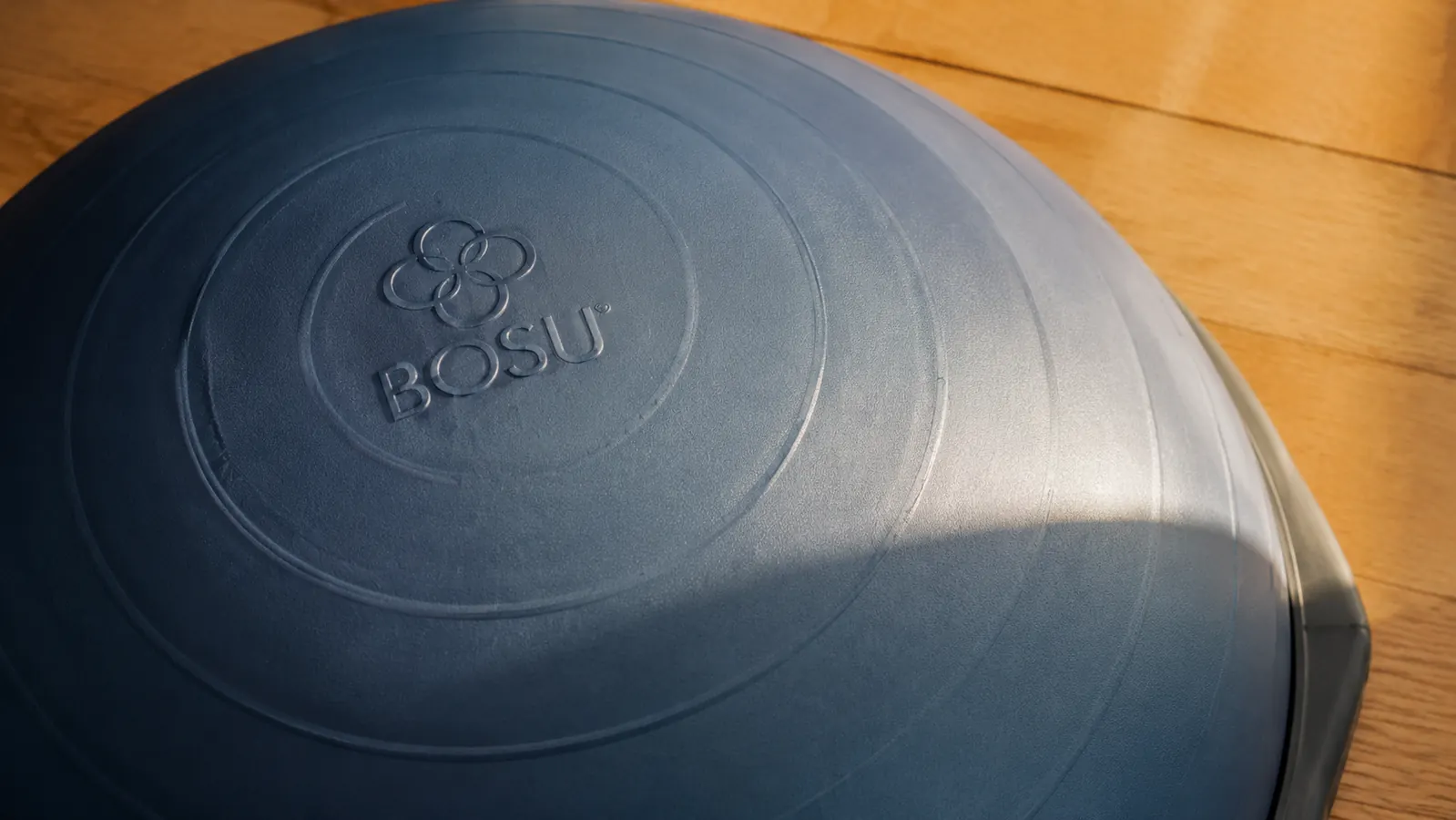 Close-up of the Bosu balance trainer dome surface showing the firm rubber texture and the BOSU logo, dome facing up