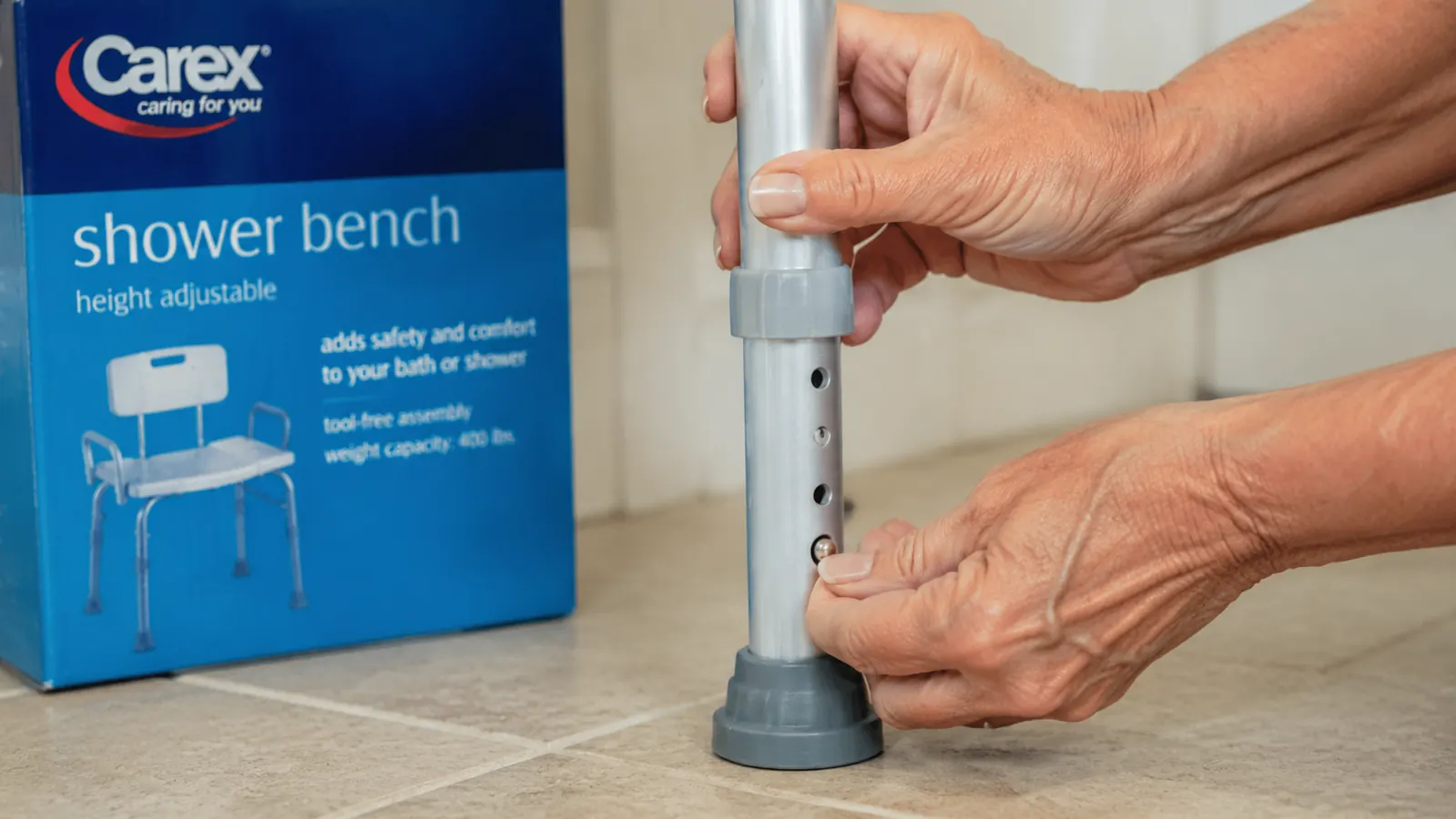 Close-up of the Carex shower bench height-adjustable legs with push-button adjustment mechanism